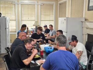 A group of people sitting around a table eating.