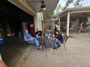 A group of people sitting at an outdoor table.