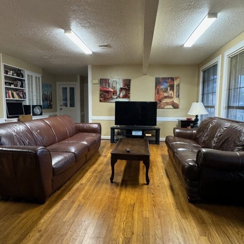 A living room with two couches and a television.